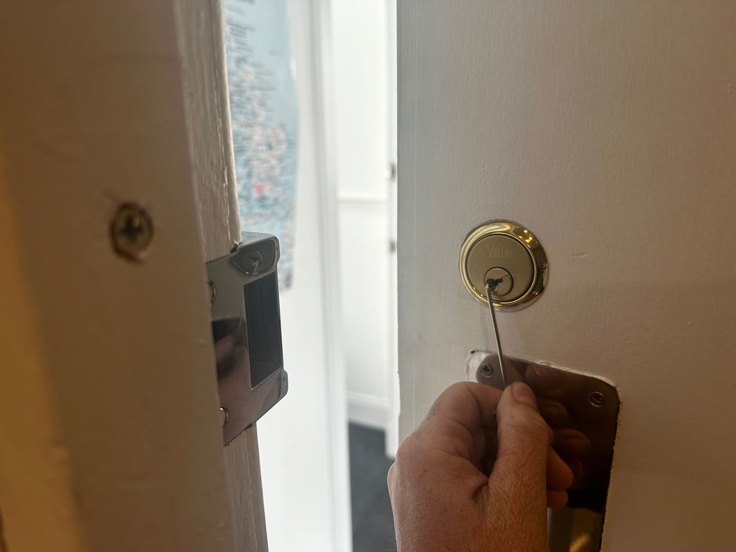 LKC locksmith picking a Yale nightlatch open without damaging the door